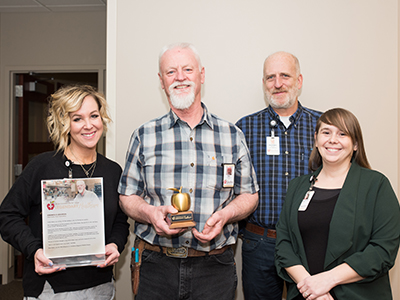 Image of JRMC Plant Operations employee, Dann Holm, receiving the Legend Award for his compassionate nature.