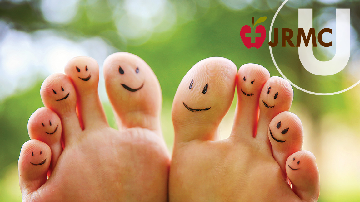 cute feet with smiling faces on the toes