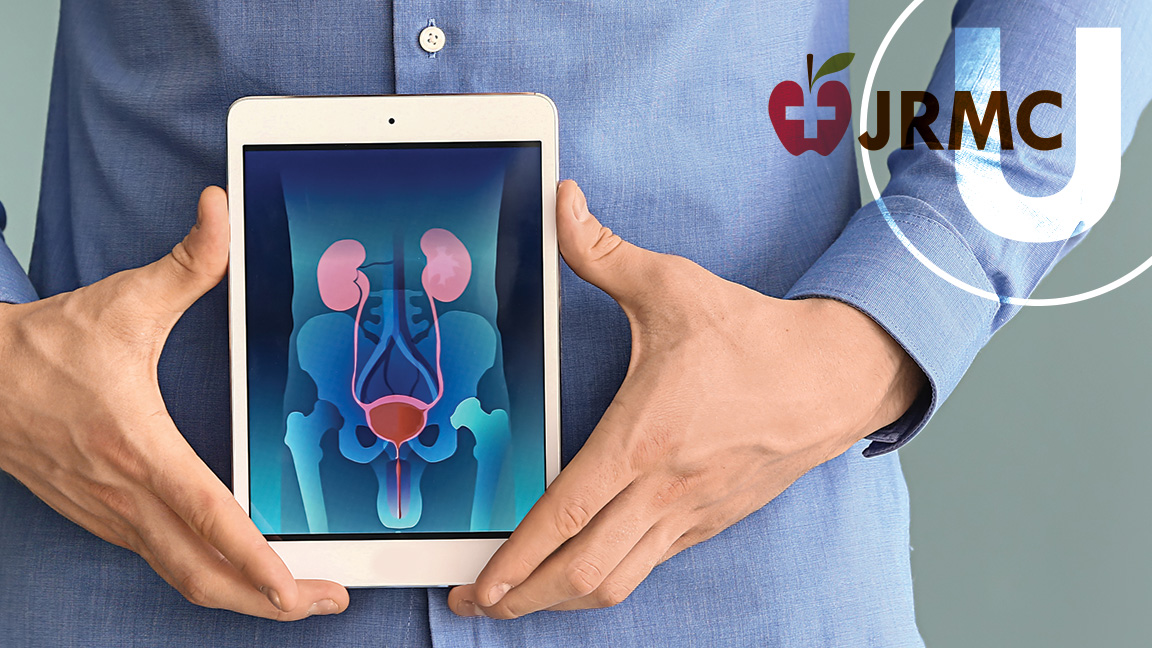 man holding tablet with medical diagram of kidneys, bladder and prostate
