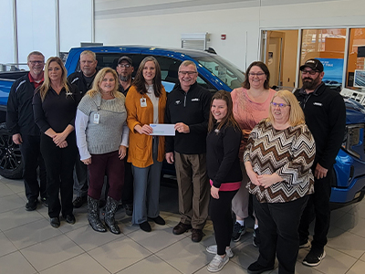 Puklich Chevrolet of Valley City presents JRMC Foundation Director Lisa Jackson a check to support cancer care.