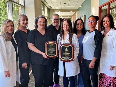 Image of Wound & Hyperbaric Center providers and nurses holding Healogics awards.