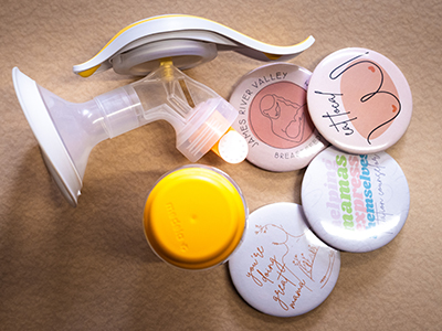 Image of breast pump and pins of local support resources.