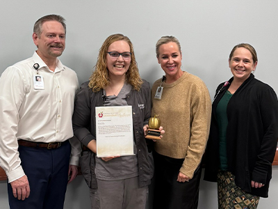 Image of JRMC leadership awarding Marissa Sinclair the Legend Award