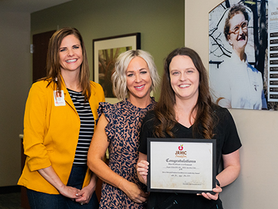 Image of Tonya Perkins and Trisha Jungels present Megan Hillius with the Nora Melvold Paulson Excellence in Nursing Award.