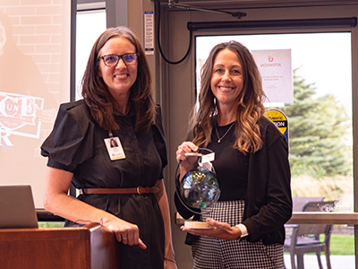 Image of Foundation Director Lisa Jackson awarding Sandy Korbel of Alerus Financial the Community Difference Partner of the Year Award.