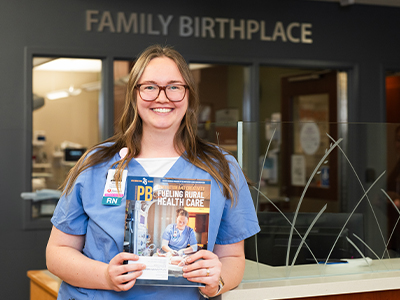 Image of JRMC Family BirthPlace Registered Nurse Whitney Steinolfson holding Prairie Business magazine.