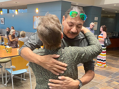 Raymond Luehr hugs JRMC Hospice Coordinator Maren Radi.